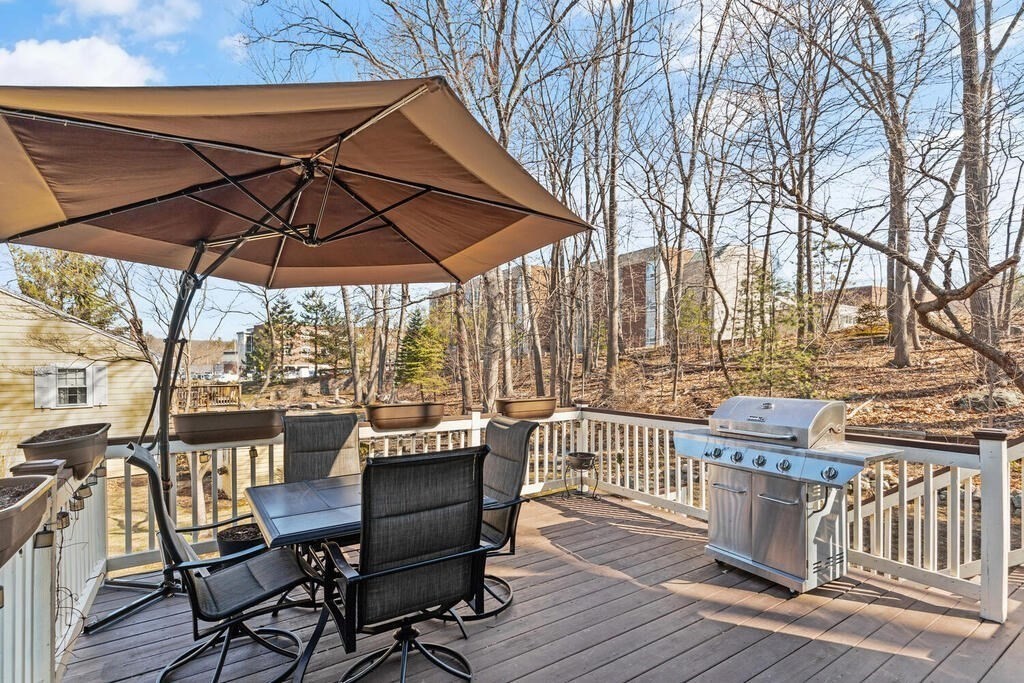 73 Longfellow Road Reading, MA 01867 - Photo 28 of 32 a view of a patio with table and chairs under an umbrella
