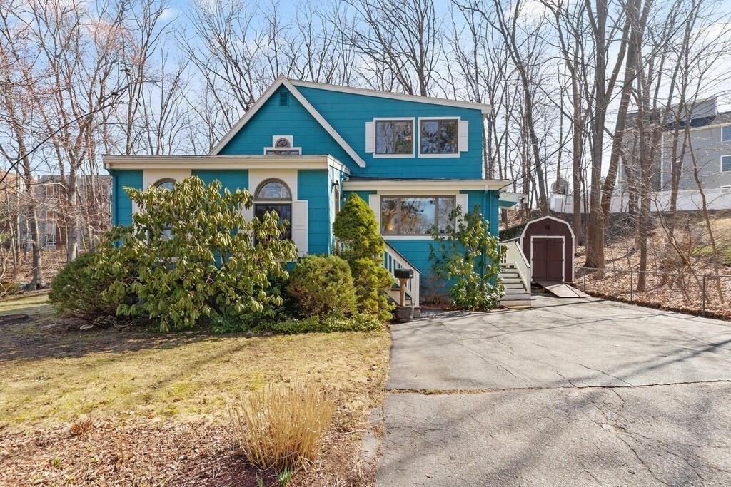 73 Longfellow Road Reading, MA 01867 - Photo 3 of 32 a front view of a house with garden