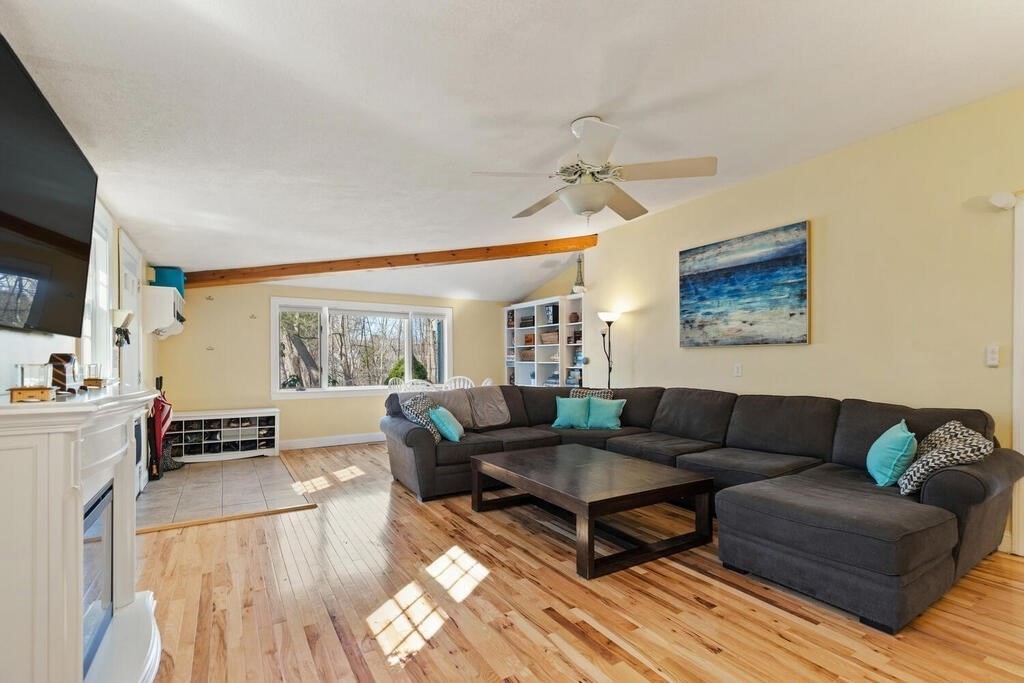 73 Longfellow Road Reading, MA 01867 - Photo 4 of 32 a living room with furniture and a flat screen tv