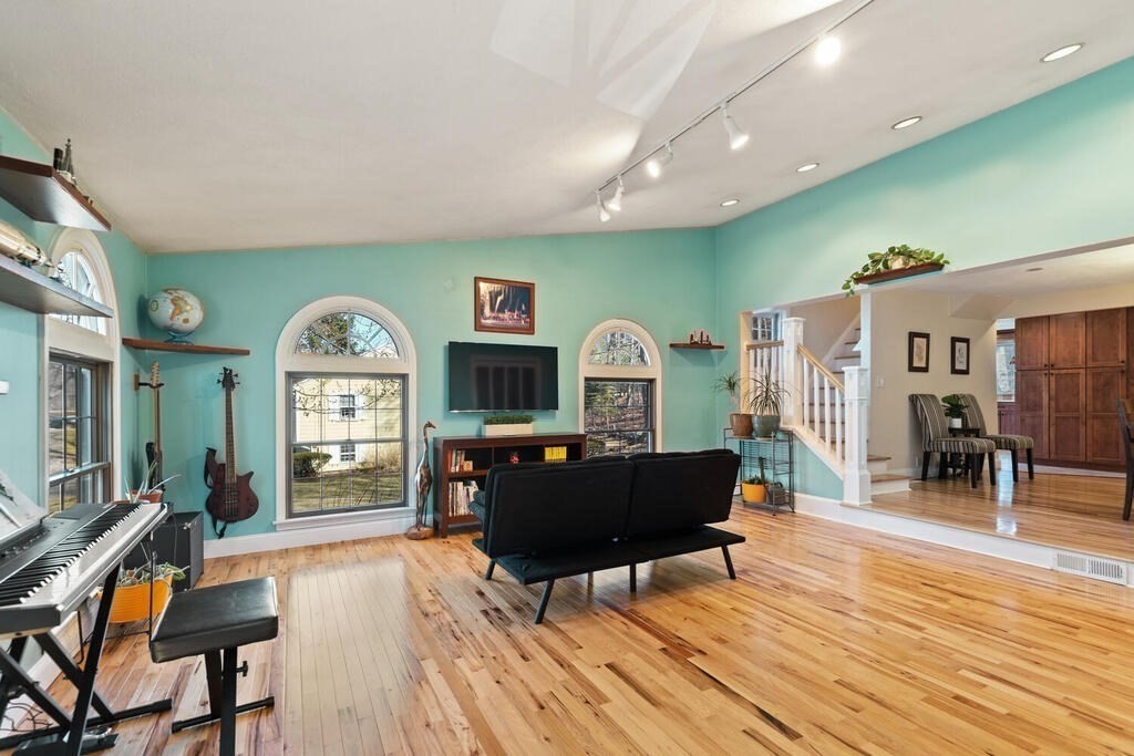 73 Longfellow Road Reading, MA 01867 - Photo 9 of 32 a living room with furniture and a wooden floor