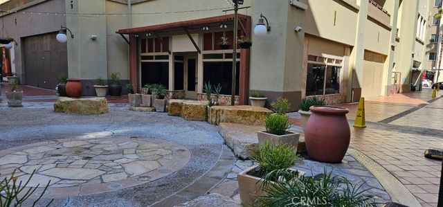 a view of a patio with plants and chairs