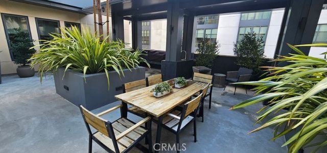 a backyard of a house with barbeque oven table and chairs