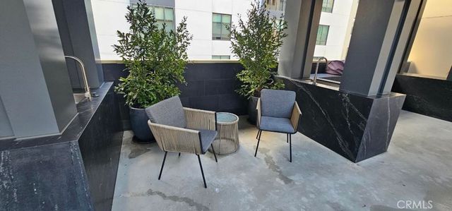 a view of a chairs and table in the balcony