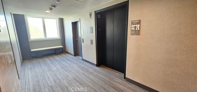 a view of hallway with wooden floor