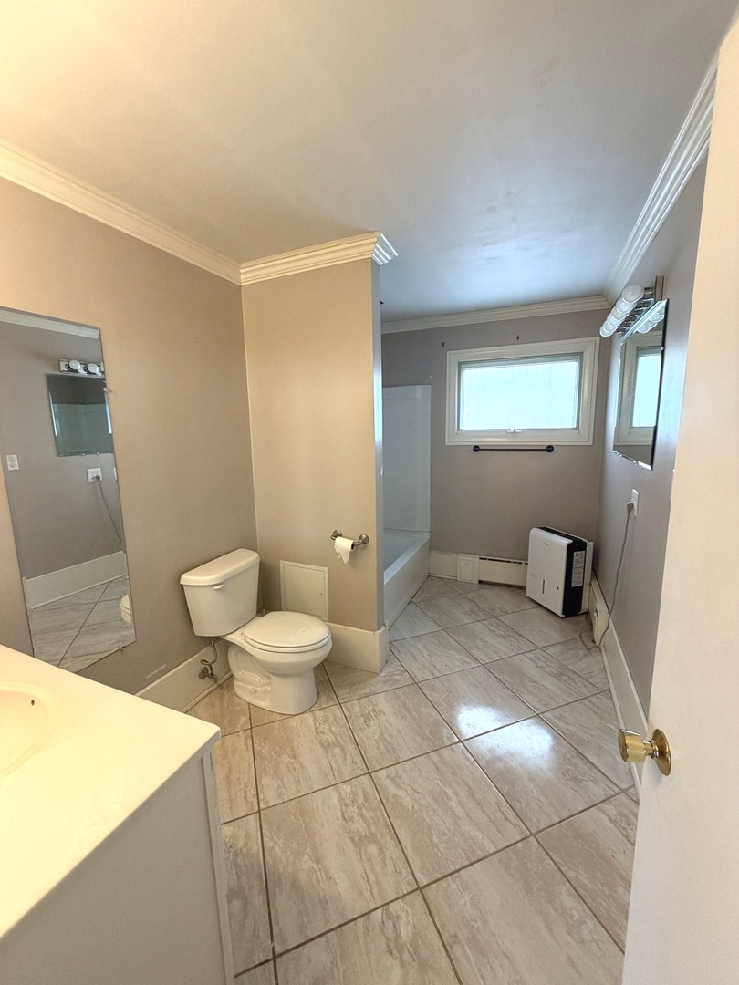 401 North Street Mazon, IL 60444 - Photo 12 of 23 a bathroom with a toilet a sink a shower and mirror
