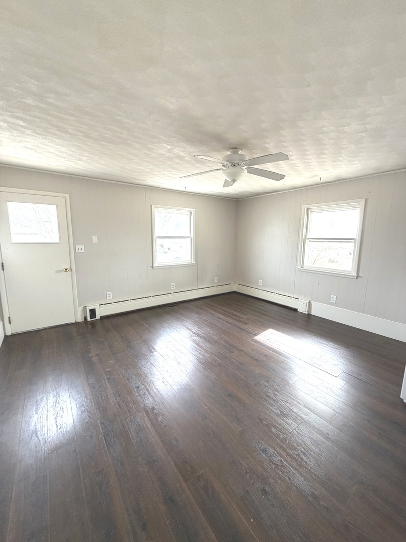 401 North Street Mazon, IL 60444 - Photo 19 of 23 an empty room with wooden floor and windows
