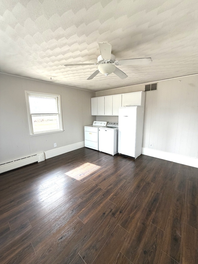 401 North Street Mazon, IL 60444 - Photo 20 of 23 an empty room with wooden floor and windows