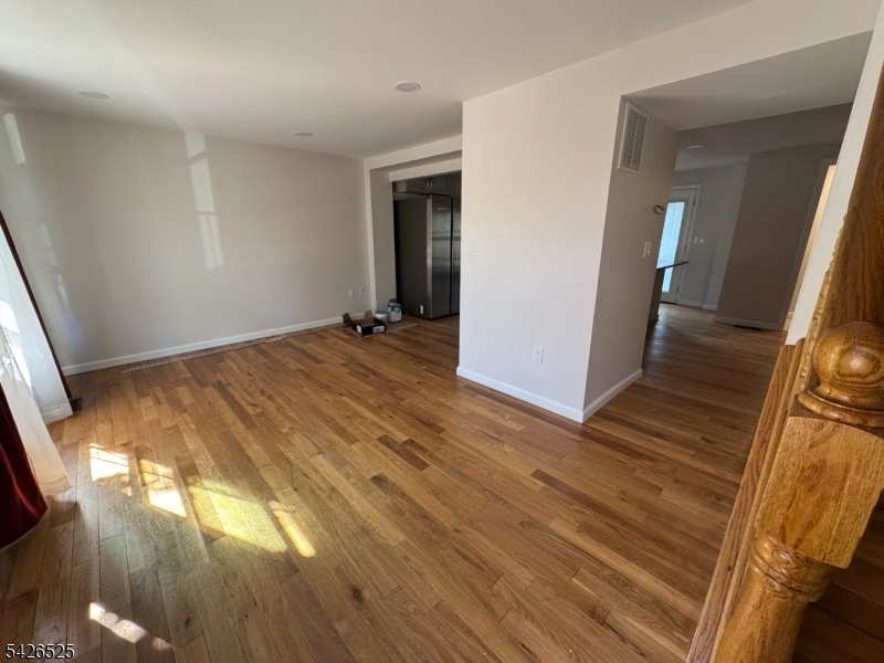 87 Fairview Avenue Somerville, NJ 08876 - Photo 11 of 19 a view of an empty room with wooden floor and a window