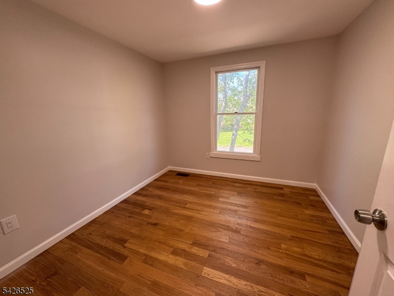 87 Fairview Avenue Somerville, NJ 08876 - Photo 16 of 19 wooden floor and window in an empty room