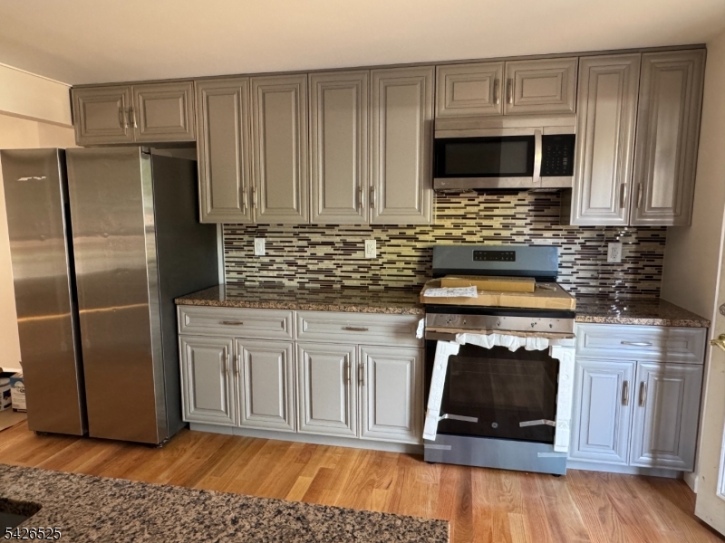 87 Fairview Avenue Somerville, NJ 08876 - Photo 2 of 19 a kitchen with stainless steel appliances granite countertop a stove microwave and refrigerator