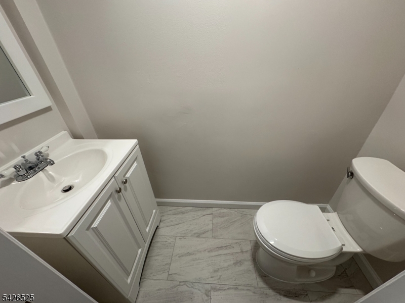87 Fairview Avenue Somerville, NJ 08876 - Photo 5 of 19 a white toilet sitting next to a bathroom sink