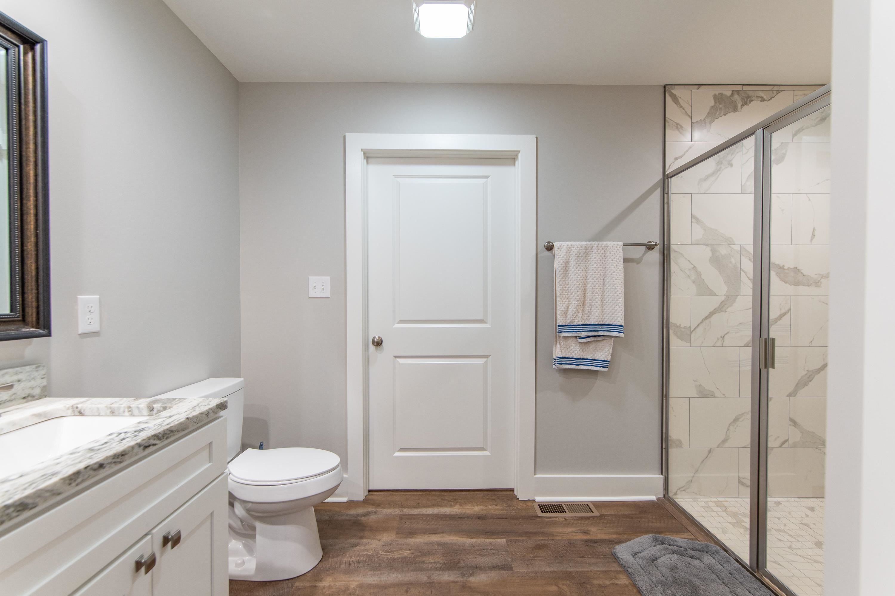 85 Rustic Trail Counce, TN 38326 - Photo 12 of 24 a bathroom with a granite countertop sink a toilet and shower