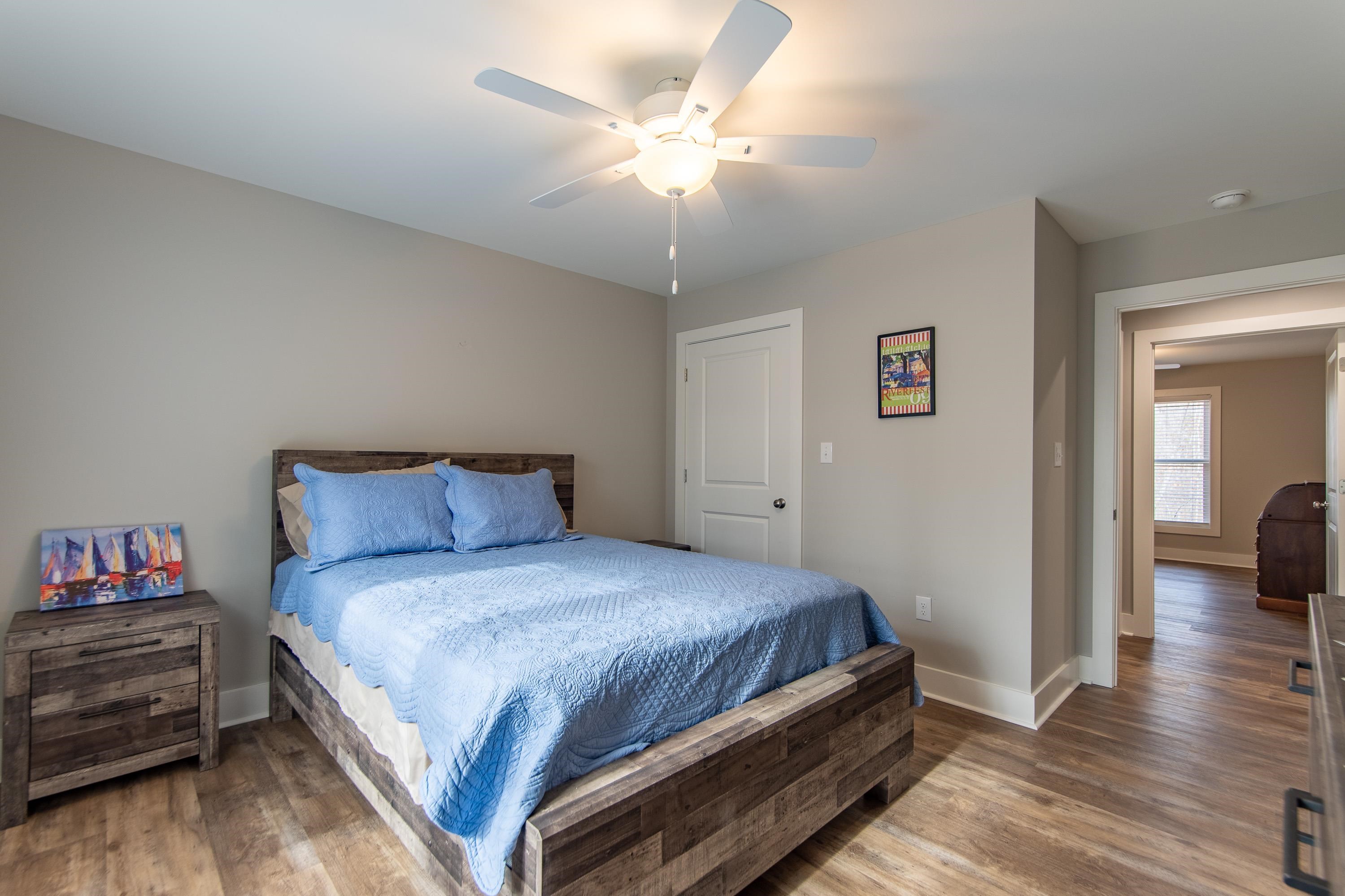 85 Rustic Trail Counce, TN 38326 - Photo 14 of 24 a bedroom with a bed and a chandelier