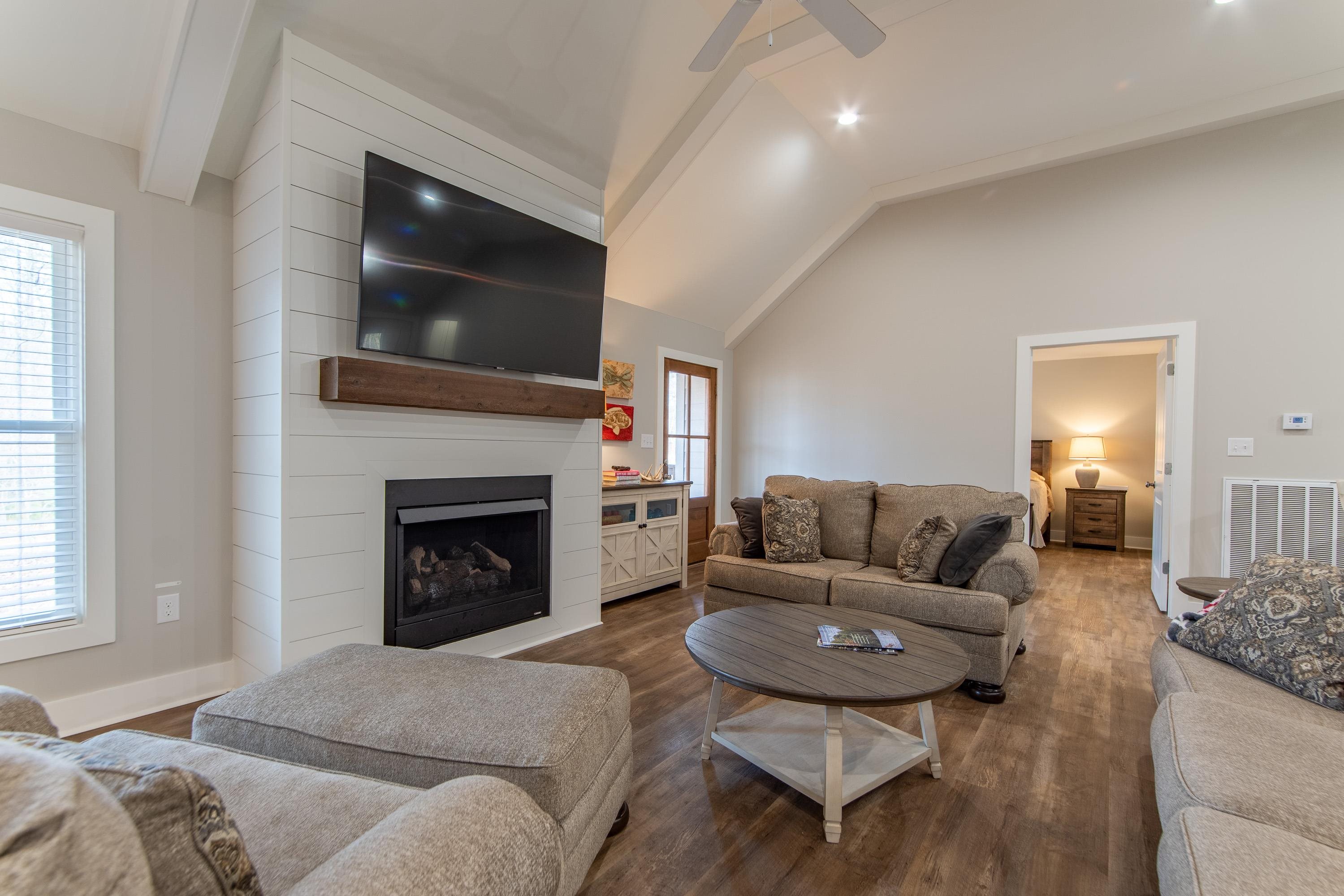 85 Rustic Trail Counce, TN 38326 - Photo 3 of 24 a living room with furniture a flat screen tv and a fireplace