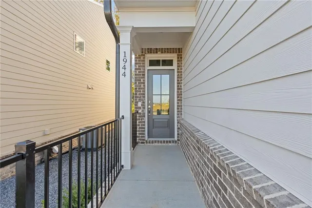 an entryway in a hall with wooden floor and a window
