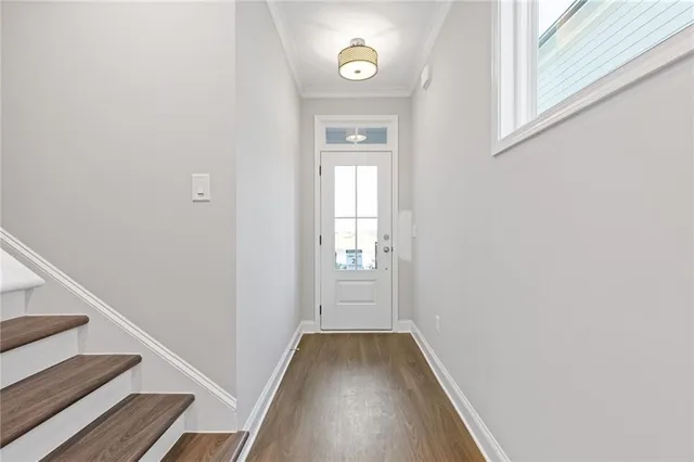 a large kitchen with granite countertop a large window a sink and stainless steel appliances