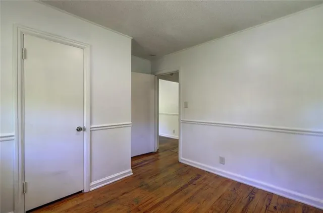 an empty room with wooden floor