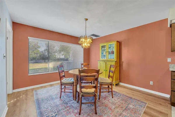 a dining room with furniture and window