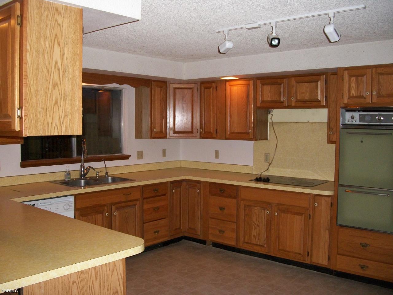 6261 Ashue Road Wapato, WA 98951 - Photo 6 of 15 a kitchen with a sink and cabinets
