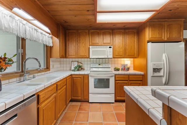 a dining room with furniture a fireplace and wooden floor