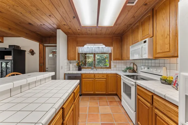 a spacious bedroom with a bed a mirror and a table