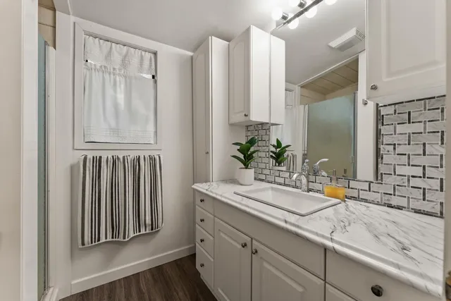 a spacious bedroom with a bed and a window