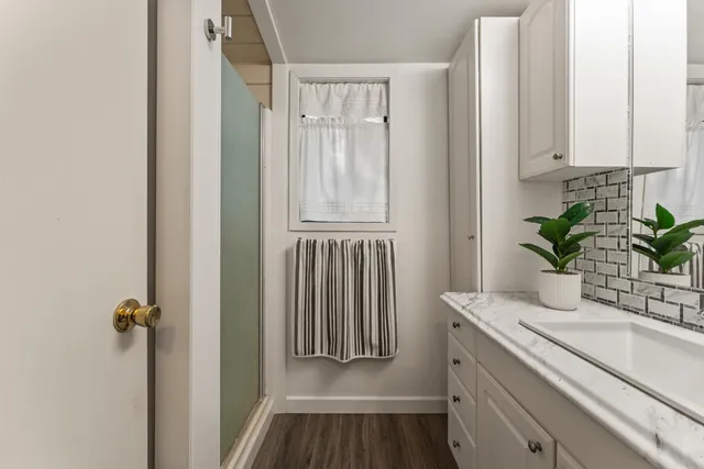 a view of room with window and wooden floor