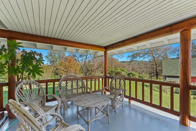 an aerial view of a house with a yard and trees