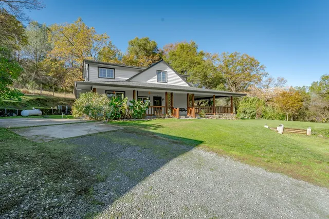 an aerial view of a houses with a yard