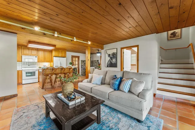 a large kitchen with stainless steel appliances granite countertop a sink and cabinets