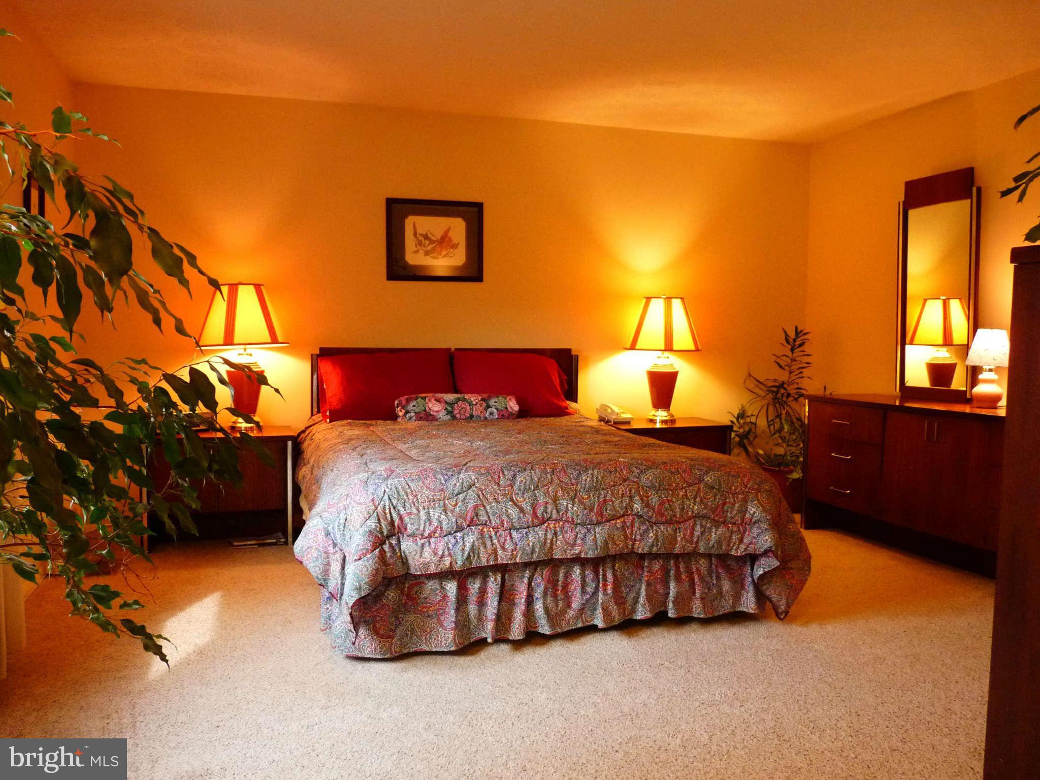 4 Box Baltimore, MD 21221 - Photo 11 of 30 a bed sitting in a bedroom next to a lamp