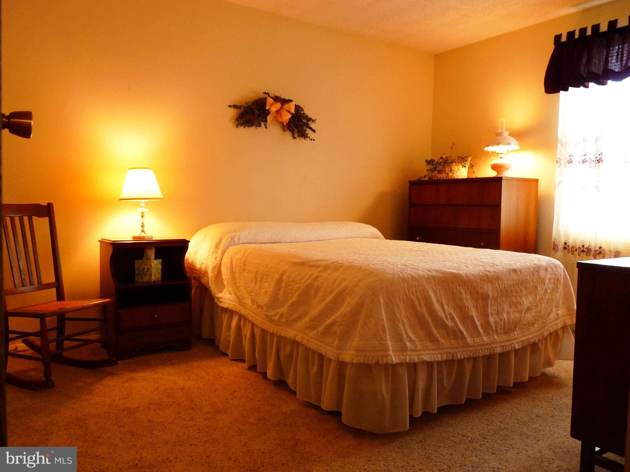 4 Box Baltimore, MD 21221 - Photo 13 of 30 a bed sitting in a bedroom next to a lamp