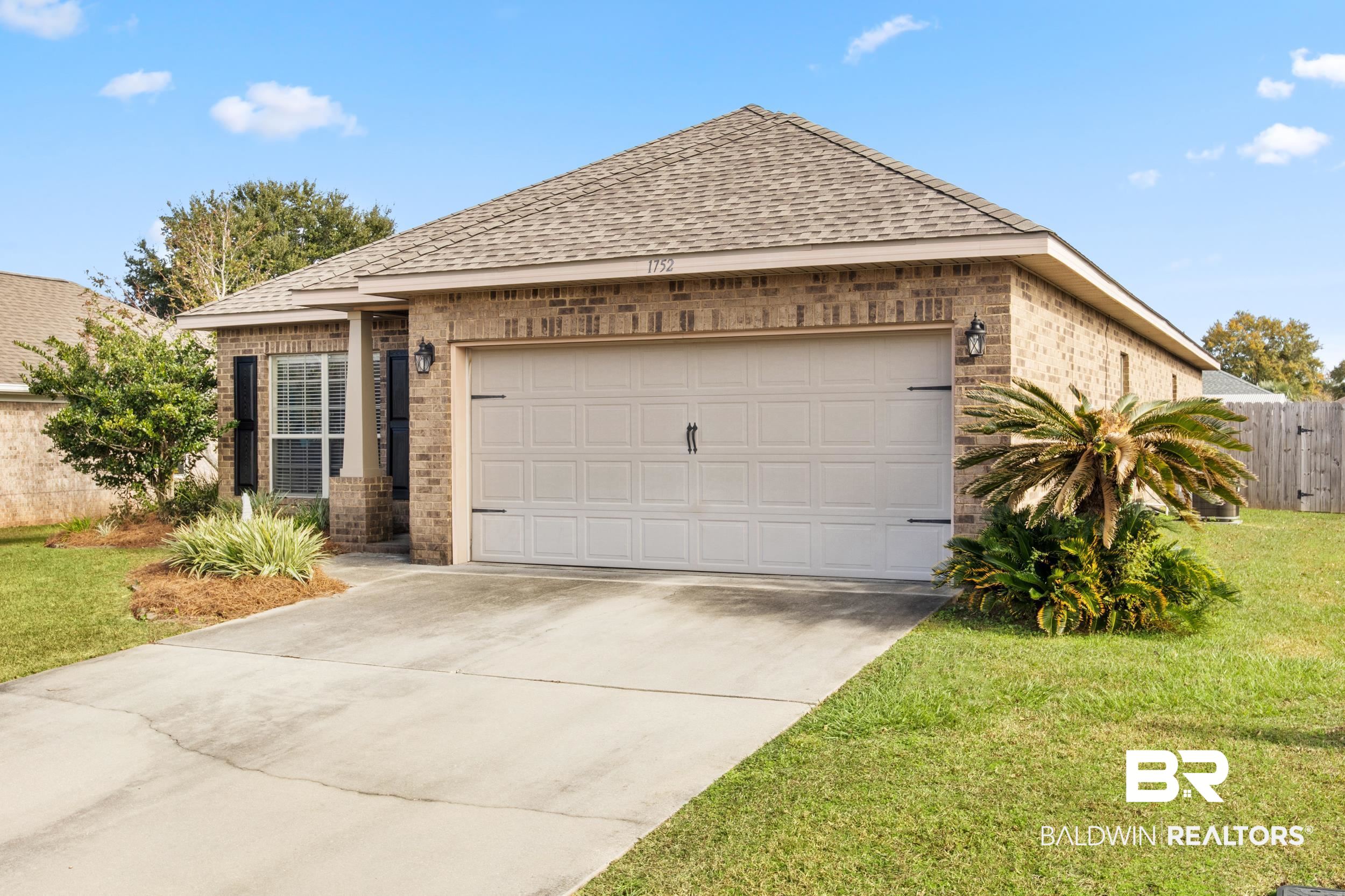 1752 Abbey Loop Foley, AL 36535 - Photo 21 of 21 View of front of property with a front yard and a garage