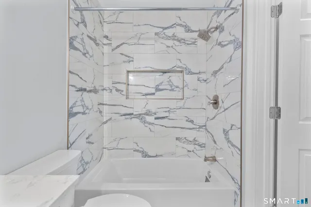 a bathroom with a bathtub and shower