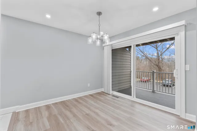 a view of a room with wooden floor and windows