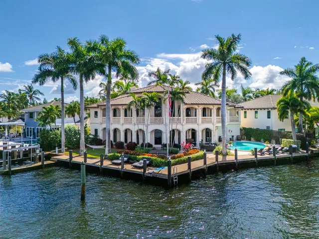 a view of a lake with couches chairs and a table