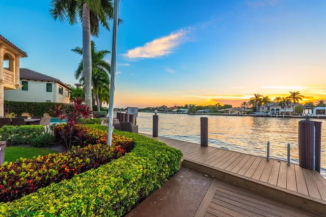 a view of a kitchen with kitchen island large windows and stainless steel appliances