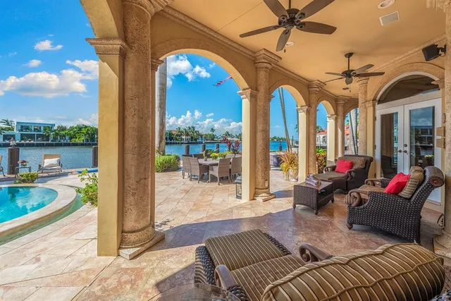a living room with furniture a dining table and a chandelier