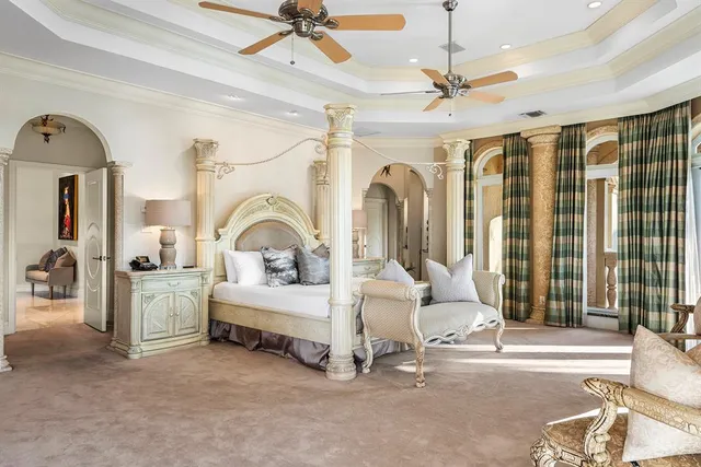 a living room with furniture a chandelier and a flat screen tv