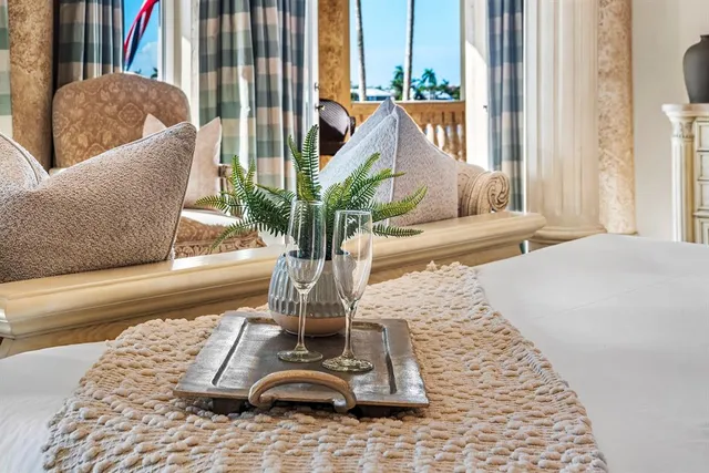 a bathroom with a granite countertop sink toilet a mirror and window