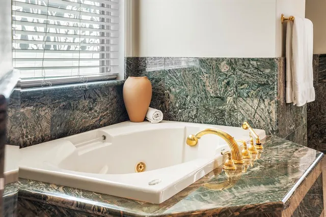 a bed room with a bed couch and a ceiling fan