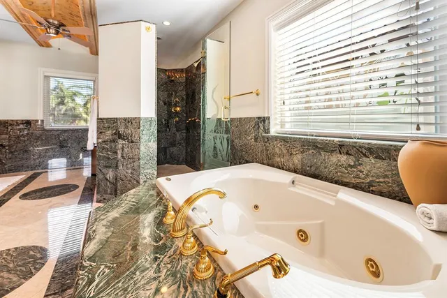 a bathroom with a granite countertop sink mirror vanity and toilet
