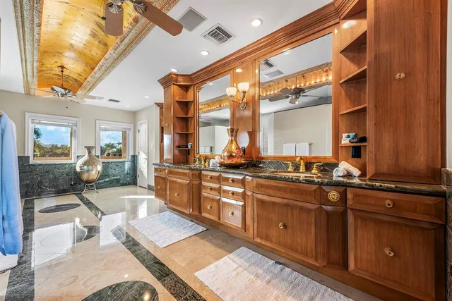 a view of a swimming pool with outdoor seating lounge chairs