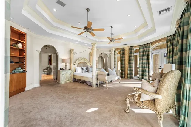 a bedroom with a large bed and a tv