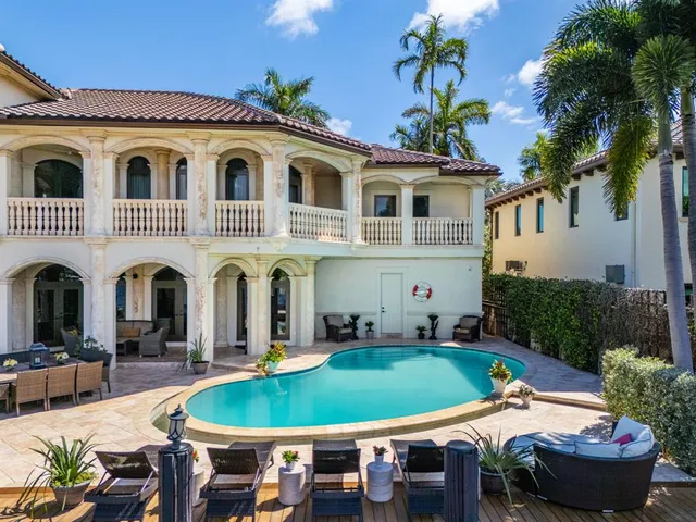 a living room with furniture a floor to ceiling window and a flat screen tv