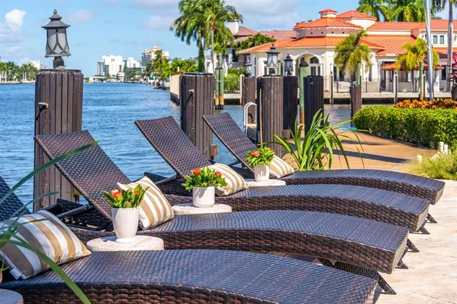 a view of ocean with boats and palm trees