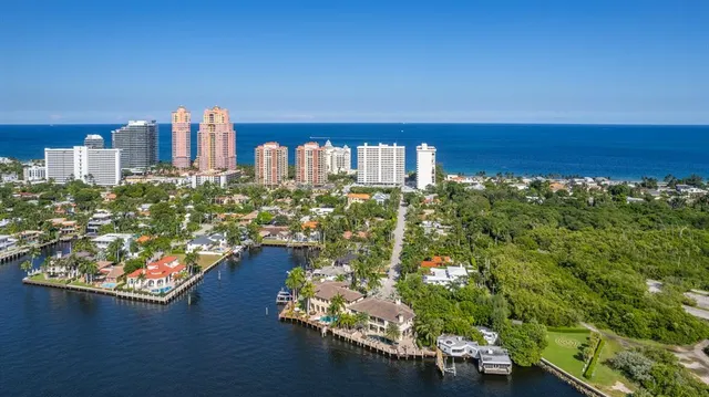 a living room with furniture a fireplace and a chandelier