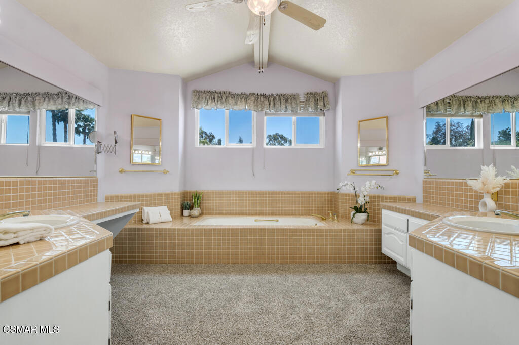5339 Seneca Place Simi Valley, CA 93063 - Photo 46 of 76 a spacious bathroom with a granite countertop tub sink and mirror