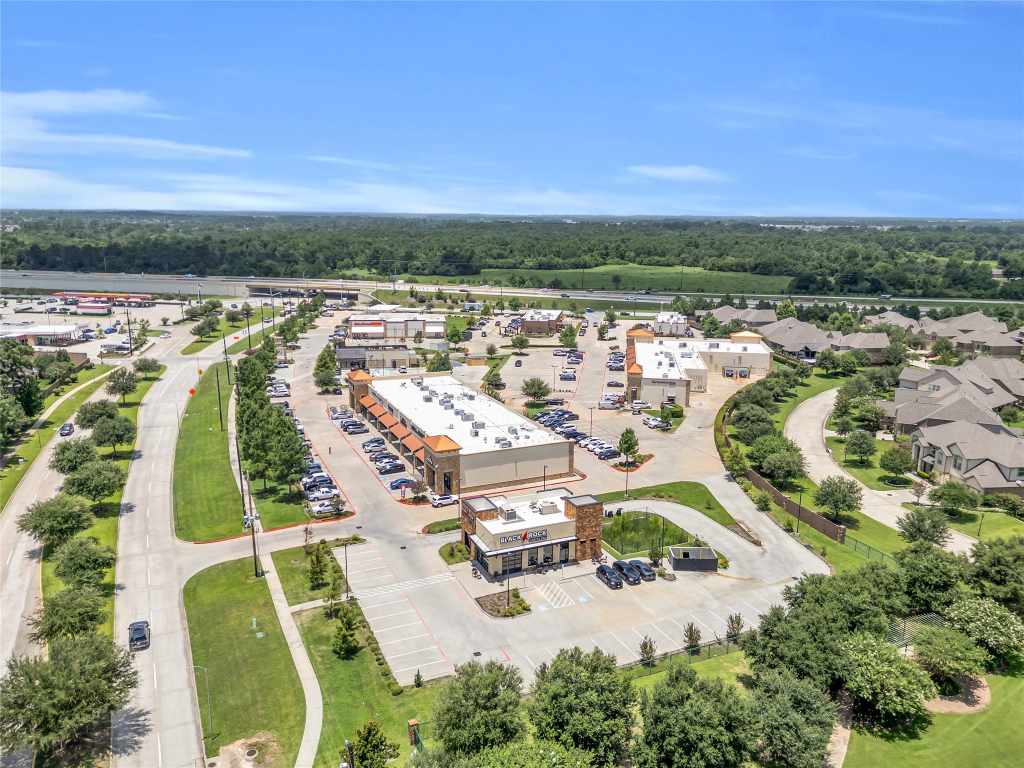 9842 Kirkstone Terrace Drive Spring, TX 77379 - Photo 32 of 34 Shopping area with multiple shops and ample parking, surrounded by lush greenery and nearby residential neighborhoods, offering convenient access to amenities.