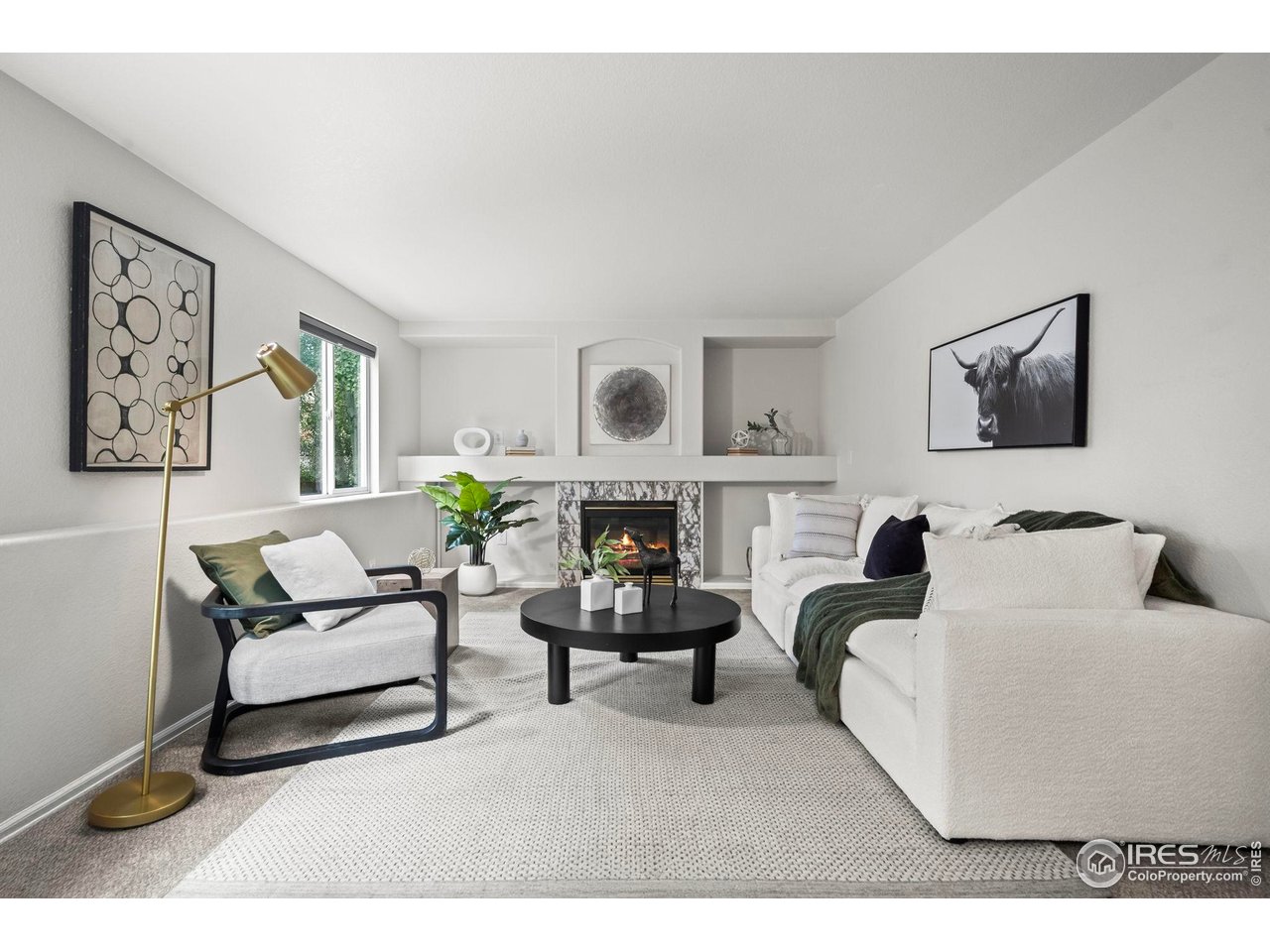 2529 Azalea Way Erie, CO 80516 - Photo 13 of 32 a living room with furniture a fireplace and paintings on the wall